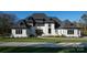 Stunning two-story home showcasing black frame windows, white painted brick, and a manicured lawn at 1004 Maxwell Ct # 1, Marvin, NC 28173