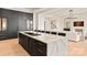Modern kitchen featuring marble countertops, black cabinets, and a large island with seating at 1004 Maxwell Ct # 1, Marvin, NC 28173