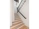 Bright staircase with wooden treads, white risers, and black metal railing at 1004 Maxwell Ct # 1, Marvin, NC 28173