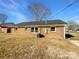 Exterior view of the brick home with a spacious backyard and established landscaping at 1188 Parkmont Ln, Rock Hill, SC 29730