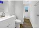 Modern bathroom features white fixtures, tile accents and flooring, and natural lighting at 1188 Parkmont Ln, Rock Hill, SC 29730
