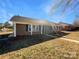 Charming brick home featuring dark shutters, a covered porch, and a well-maintained lawn at 1188 Parkmont Ln, Rock Hill, SC 29730