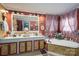 Beautiful bathroom featuring double sinks, vanity lighting, and soaking tub surrounded by decorations at 120 Dixie Dr, Shelby, NC 28021