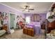Ornate and eccentric bedroom with purple walls and bedding, with vintage furniture and decor at 120 Dixie Dr, Shelby, NC 28021