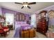 Lovely bedroom featuring purple walls, a large bed, decorative pillows, and antique furniture at 120 Dixie Dr, Shelby, NC 28021