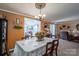 Traditional dining room with orange walls and antique furniture next to an adjacent living room at 120 Dixie Dr, Shelby, NC 28021