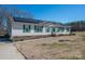 Charming home with green shutters, brick accents, and solar panels on a sunny day at 120 Dixie Dr, Shelby, NC 28021