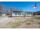 Well-maintained home exterior showcasing green shutters, solar panels and a manicured lawn under a clear sky at 120 Dixie Dr, Shelby, NC 28021