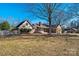 A lovely home exterior featuring a wooden fence and mature trees and shrubbery in the backyard for privacy and shade at 133 Persimmon Creek Rd # 81, Kings Mountain, NC 28086