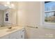 Bathroom featuring a sink, mirror, and window allowing natural light at 133 Persimmon Creek Rd # 81, Kings Mountain, NC 28086