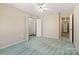 Bright bedroom with a ceiling fan, carpeted flooring, and access to a hall at 133 Persimmon Creek Rd # 81, Kings Mountain, NC 28086