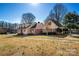 Angle shot of the charming house with lush green lawn and mature trees showcasing its appealing curb appeal at 133 Persimmon Creek Rd # 81, Kings Mountain, NC 28086