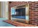 Up-close view of a beautiful brick fireplace, and a glimpse of the adjacent room, adding warmth and character at 133 Persimmon Creek Rd # 81, Kings Mountain, NC 28086