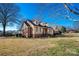 Nice eye-level view of a home with dormer windows, a brick chimney, and mature landscaping for enhanced curb appeal at 133 Persimmon Creek Rd # 81, Kings Mountain, NC 28086