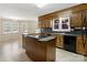 A spacious kitchen with a center island and breakfast nook with a view of the backyard at 133 Persimmon Creek Rd # 81, Kings Mountain, NC 28086
