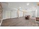 Finished basement offers versatile space with wood-look floors and accent beams at 13701 Petworth Ct, Charlotte, NC 28278