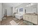 Bathroom features a soaking tub, dual vanities, and wood floors at 13701 Petworth Ct, Charlotte, NC 28278