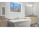 Bathroom features a soaking tub, dual vanities, and natural light at 13701 Petworth Ct, Charlotte, NC 28278