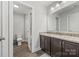Bathroom with granite counters, dark cabinetry, and a shower behind the door at 13701 Petworth Ct, Charlotte, NC 28278