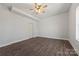 Simple bedroom offers wood-look floors, a ceiling fan, and a neutral color scheme at 13701 Petworth Ct, Charlotte, NC 28278