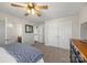 Bright bedroom features neutral decor, a ceiling fan, and double closets for storage at 13701 Petworth Ct, Charlotte, NC 28278