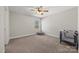 Bedroom with a neutral color scheme, a ceiling fan, and a window for natural light at 13701 Petworth Ct, Charlotte, NC 28278