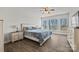 Bright bedroom featuring wood floors, night stands, and large windows overlooking the lake at 13701 Petworth Ct, Charlotte, NC 28278