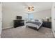 Cozy bedroom features neutral decor, a ceiling fan, and a well-placed window at 13701 Petworth Ct, Charlotte, NC 28278