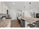 Bright kitchen features stainless steel appliances, granite countertops, a kitchen island, and wood floors at 13701 Petworth Ct, Charlotte, NC 28278