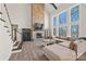 Bright living room with high ceilings, a stone fireplace, and large windows offering scenic views at 13701 Petworth Ct, Charlotte, NC 28278