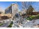 Well-maintained backyard featuring a stone patio, modern outdoor furniture, and lush greenery at 13725 Mallory Baches Ln, Huntersville, NC 28078