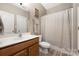 Modern bathroom with a wooden vanity, a toilet, and a shower with anchor-themed decor at 13725 Mallory Baches Ln, Huntersville, NC 28078