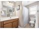 Well-lit bathroom with a wooden vanity, large mirror, and a shower-tub combination at 13725 Mallory Baches Ln, Huntersville, NC 28078