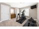 Bright bedroom featuring exercise equipment, a dresser, and a ceiling fan at 13725 Mallory Baches Ln, Huntersville, NC 28078
