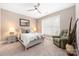 Comfortable bedroom with large window, ceiling fan, and a relaxing chair at 13725 Mallory Baches Ln, Huntersville, NC 28078