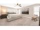 Spacious bedroom with neutral tones, large windows, ceiling fan and a rocking chair at 13725 Mallory Baches Ln, Huntersville, NC 28078