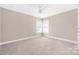 Cozy carpeted bedroom with a ceiling fan and natural light at 13725 Mallory Baches Ln, Huntersville, NC 28078