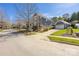 Beautiful home exterior with manicured lawn, detached garage and paved driveway on a tree lined street at 13725 Mallory Baches Ln, Huntersville, NC 28078