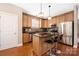 Modern kitchen with stainless steel appliances, granite countertops, and wooden cabinets at 13725 Mallory Baches Ln, Huntersville, NC 28078