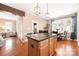 Bright kitchen features granite island, stainless appliances and hardwood floors overlooking a large living area at 13725 Mallory Baches Ln, Huntersville, NC 28078