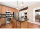 Modern kitchen with stainless steel appliances, hardwood floors and center island at 13725 Mallory Baches Ln, Huntersville, NC 28078
