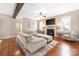 Inviting living room with hardwood floors, plush sofas, a fireplace, and large windows offering ample natural light at 13725 Mallory Baches Ln, Huntersville, NC 28078