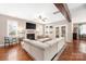 Bright living room featuring a fireplace, plush sofa, hardwood floors, and abundant natural light at 13725 Mallory Baches Ln, Huntersville, NC 28078