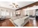 Open-concept living room showcasing hardwood floors, beam, plush sofa, and seamless flow into other living spaces at 13725 Mallory Baches Ln, Huntersville, NC 28078