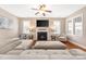 Cozy living room featuring a fireplace, plush sofa, hardwood floors, and abundant natural light at 13725 Mallory Baches Ln, Huntersville, NC 28078