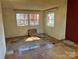 Living room with damaged floors and walls at 1406 Ratchford Dr, Dallas, NC 28034