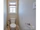 Bathroom features a toilet, wood-look floors and small window at 1529 Alex Dr, Shelby, NC 28152
