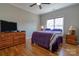 Comfortable bedroom with a window, wood floors, and a dresser with mounted TV at 1529 Alex Dr, Shelby, NC 28152