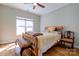 Sunlit bedroom boasts hardwood floors, a bench, and a window offering outdoor views at 1529 Alex Dr, Shelby, NC 28152