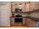 Well-organized kitchen featuring stainless steel oven, wooden cabinets, and black countertops at 1529 Alex Dr, Shelby, NC 28152